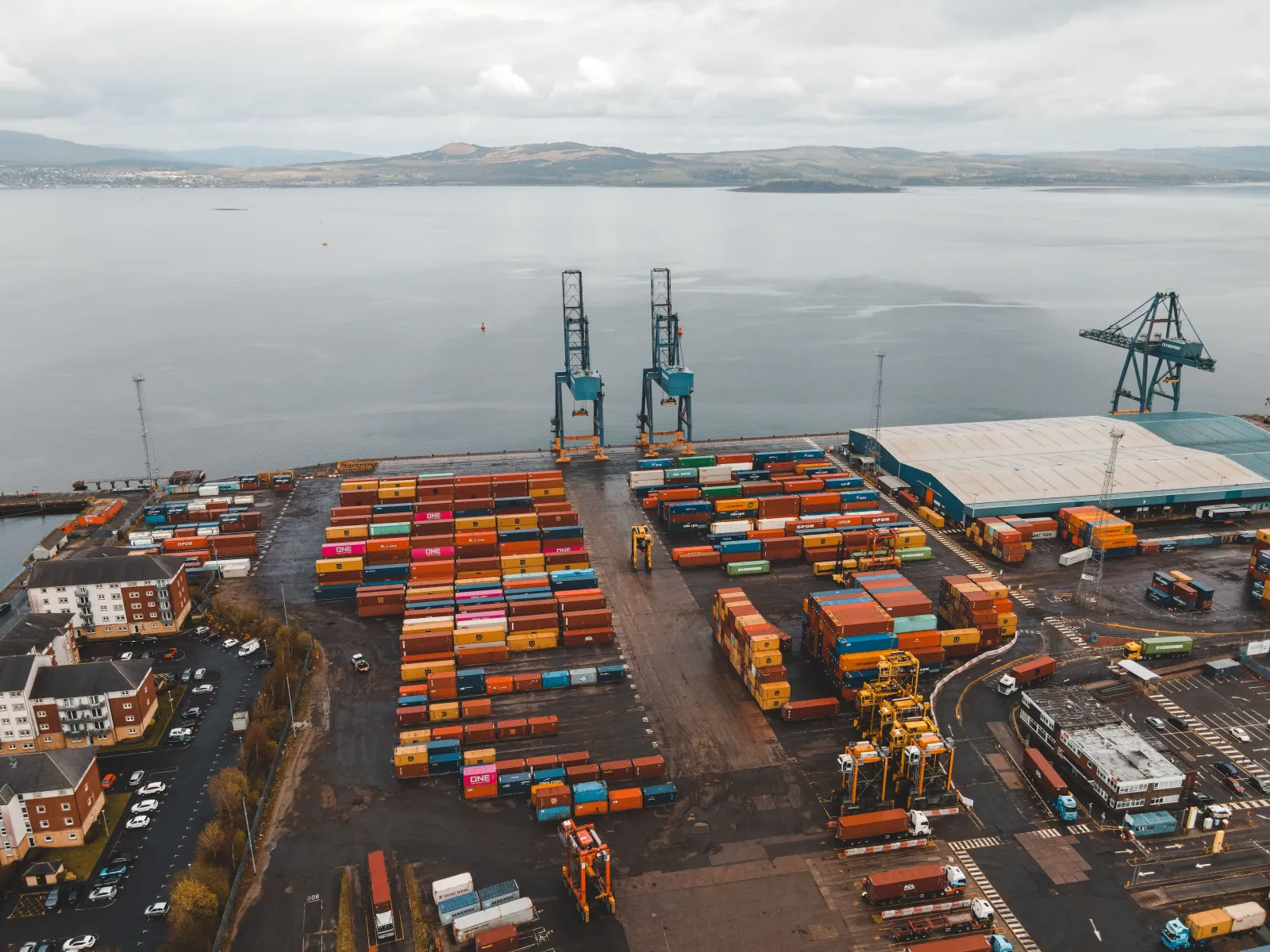 Aerial view of a container port with cranes and stacked containers